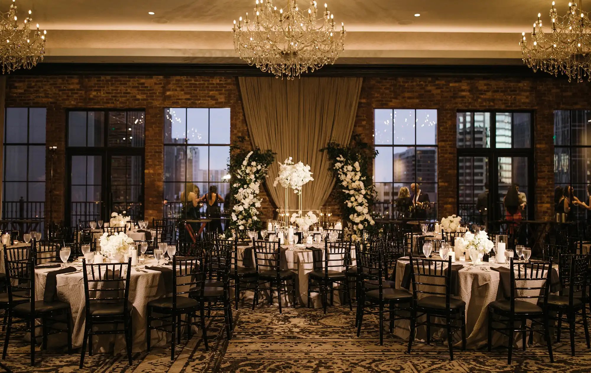 Best wedding venues in Austin - upscale rooftop reception space with city skyline views and chandelier lighting