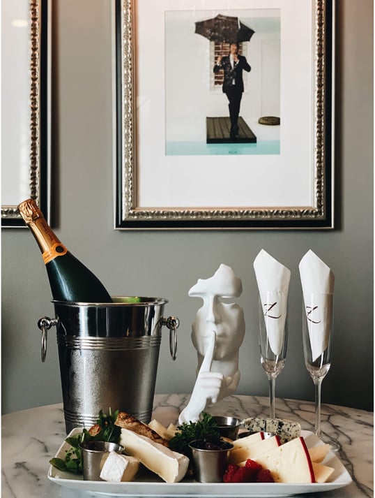 A wine bottle with a charcuterie plate